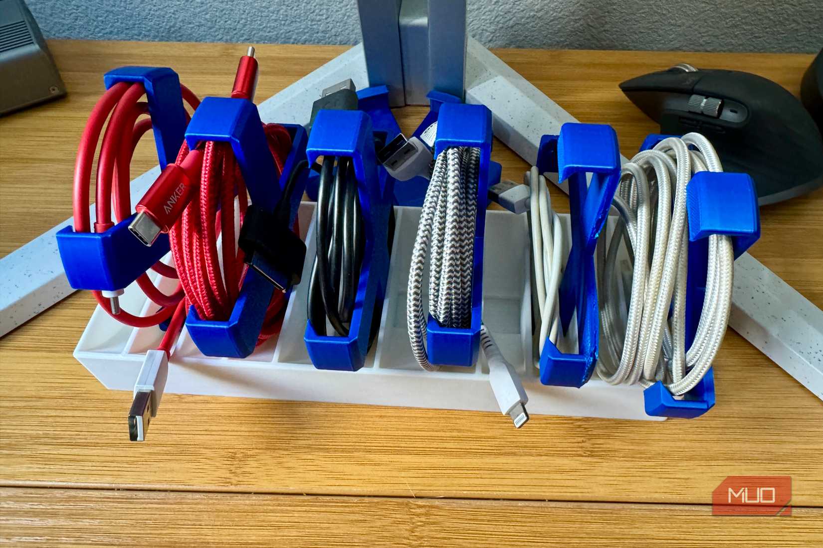 Organizer with six rolled USB cables in it