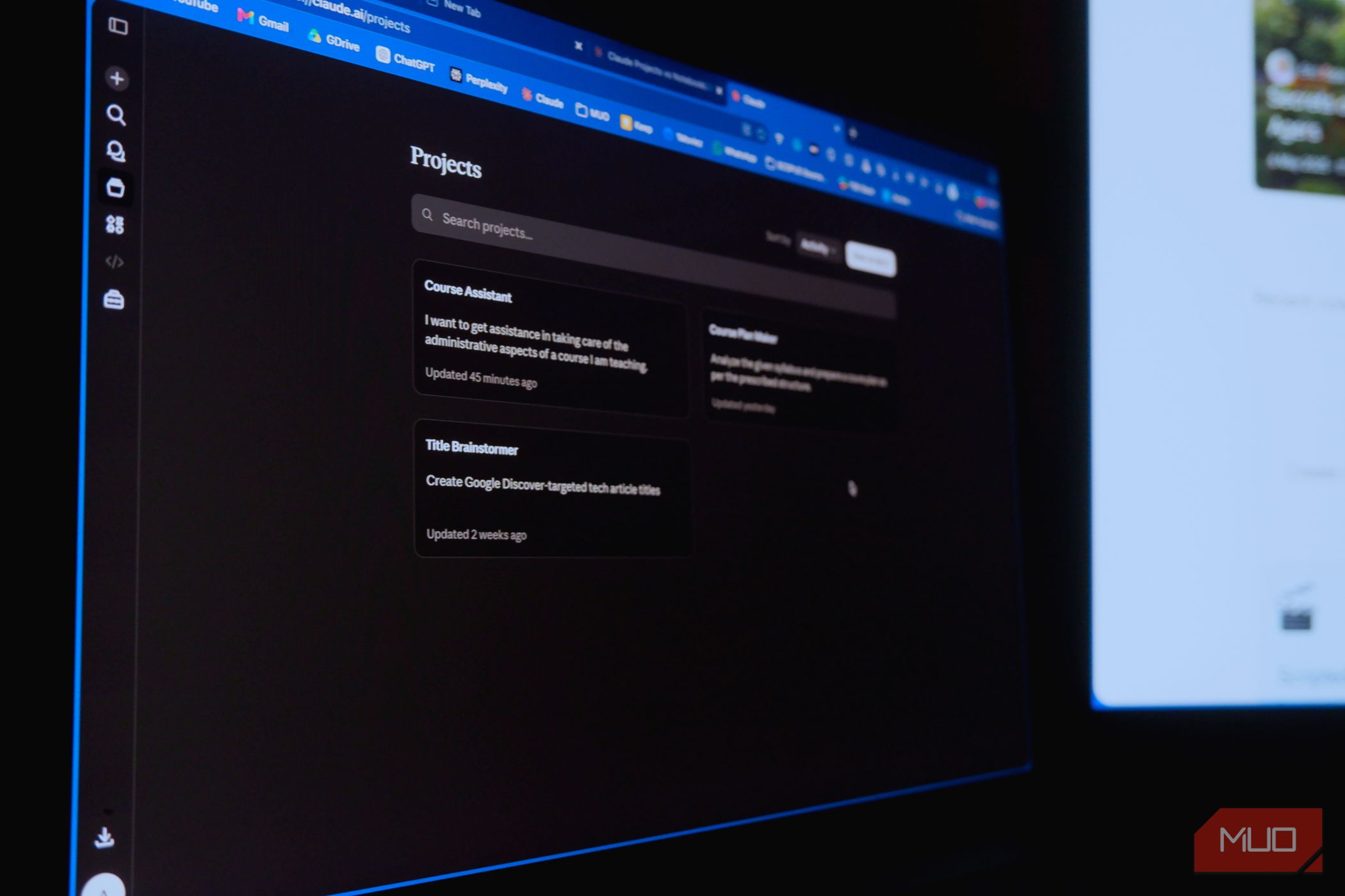 claude projects on a laptop screen and NotebookLM on another monitor