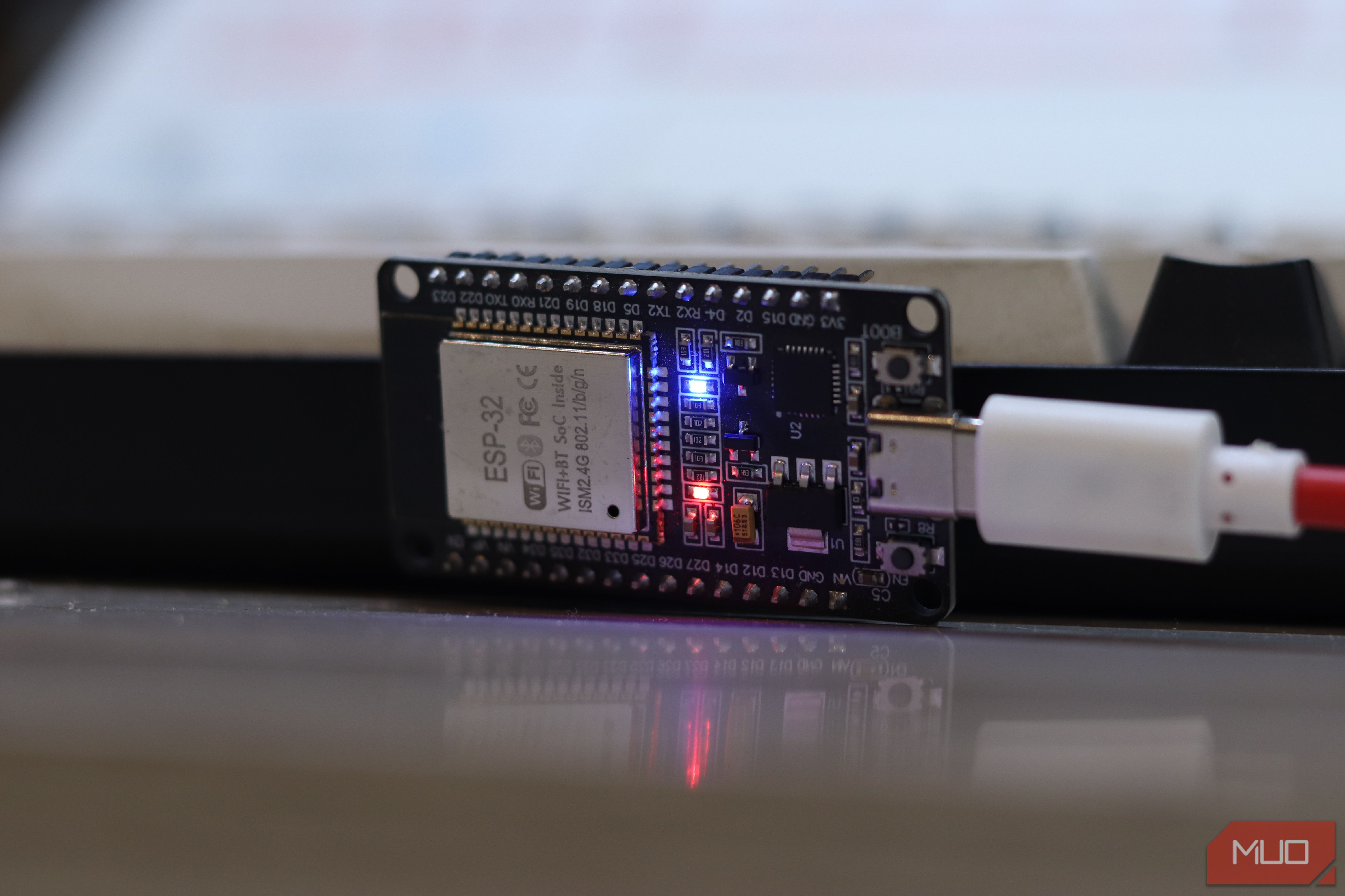 ESP32 classic board powered via USB with blue and red LEDs lit