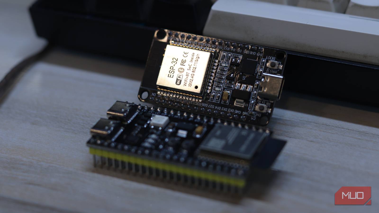 ESP32 classic module label closeup with ESP32-S3 board near keyboard