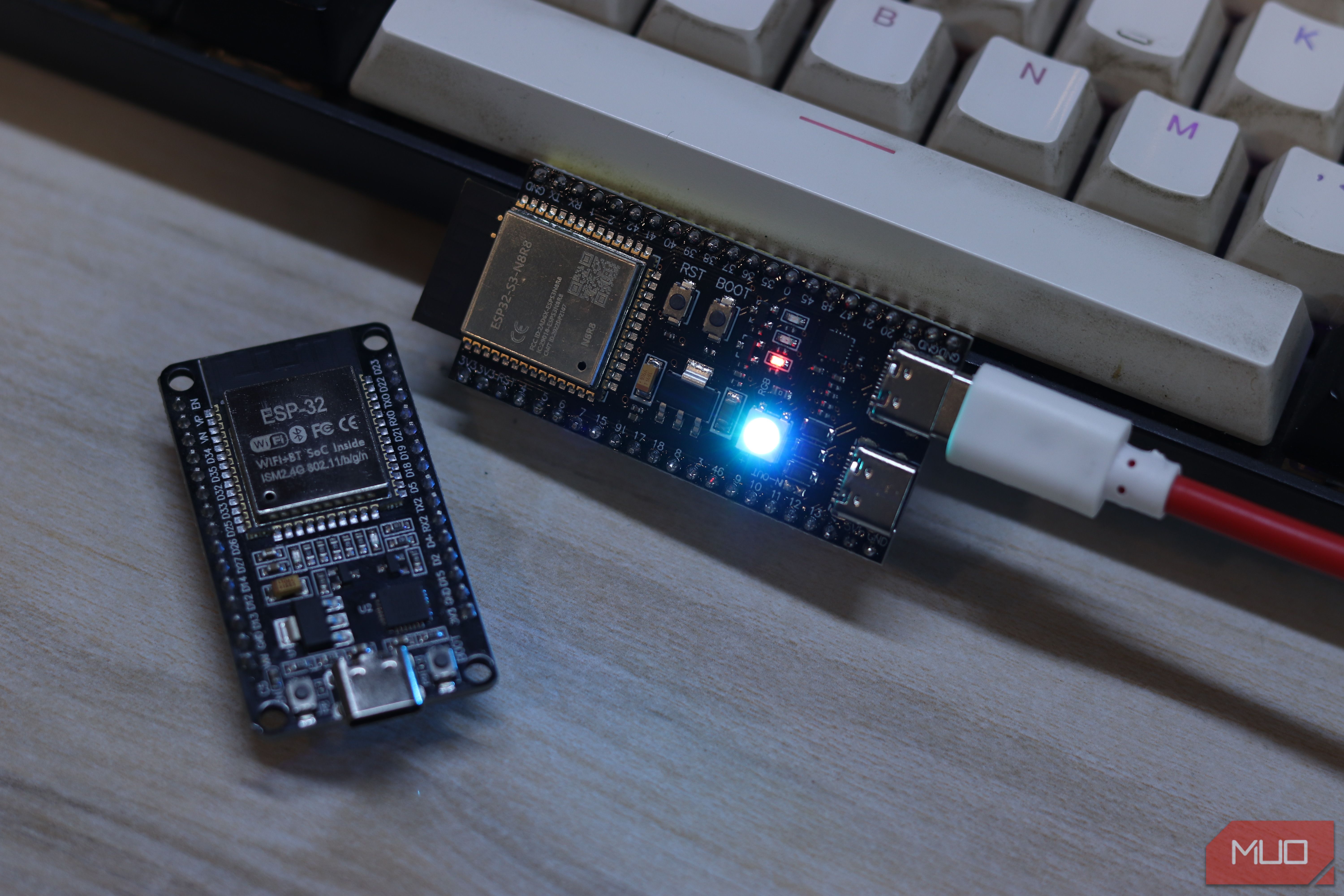 ESP32-S3 powered with blue LED on, next to unpowered ESP32 classic