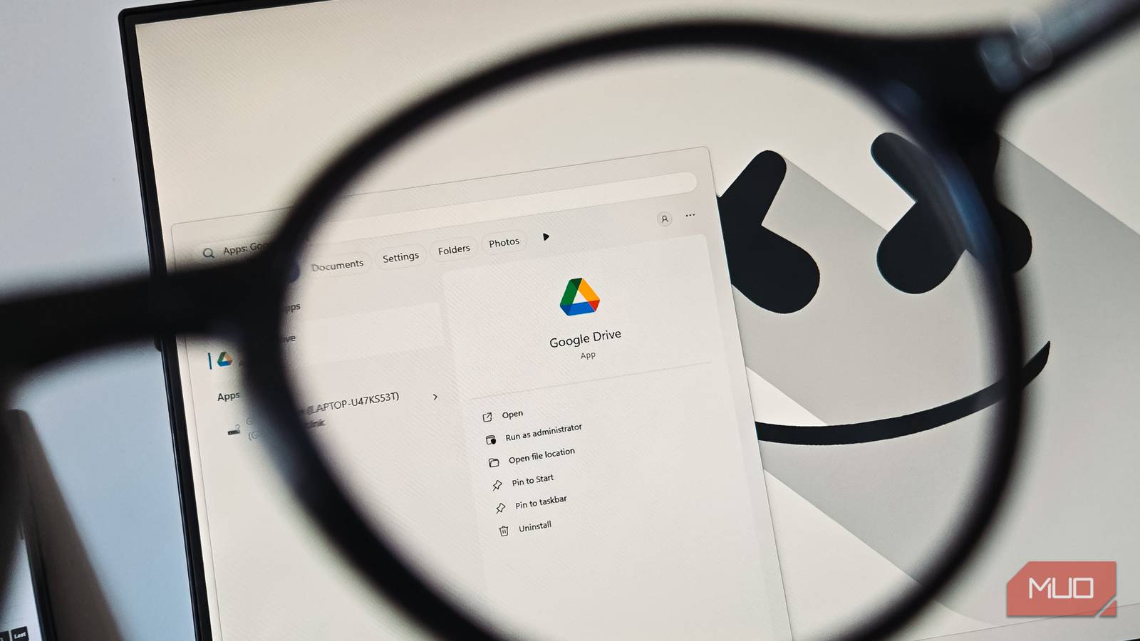 Google Drive app viewed through a magnifying glass on a Windows desktop