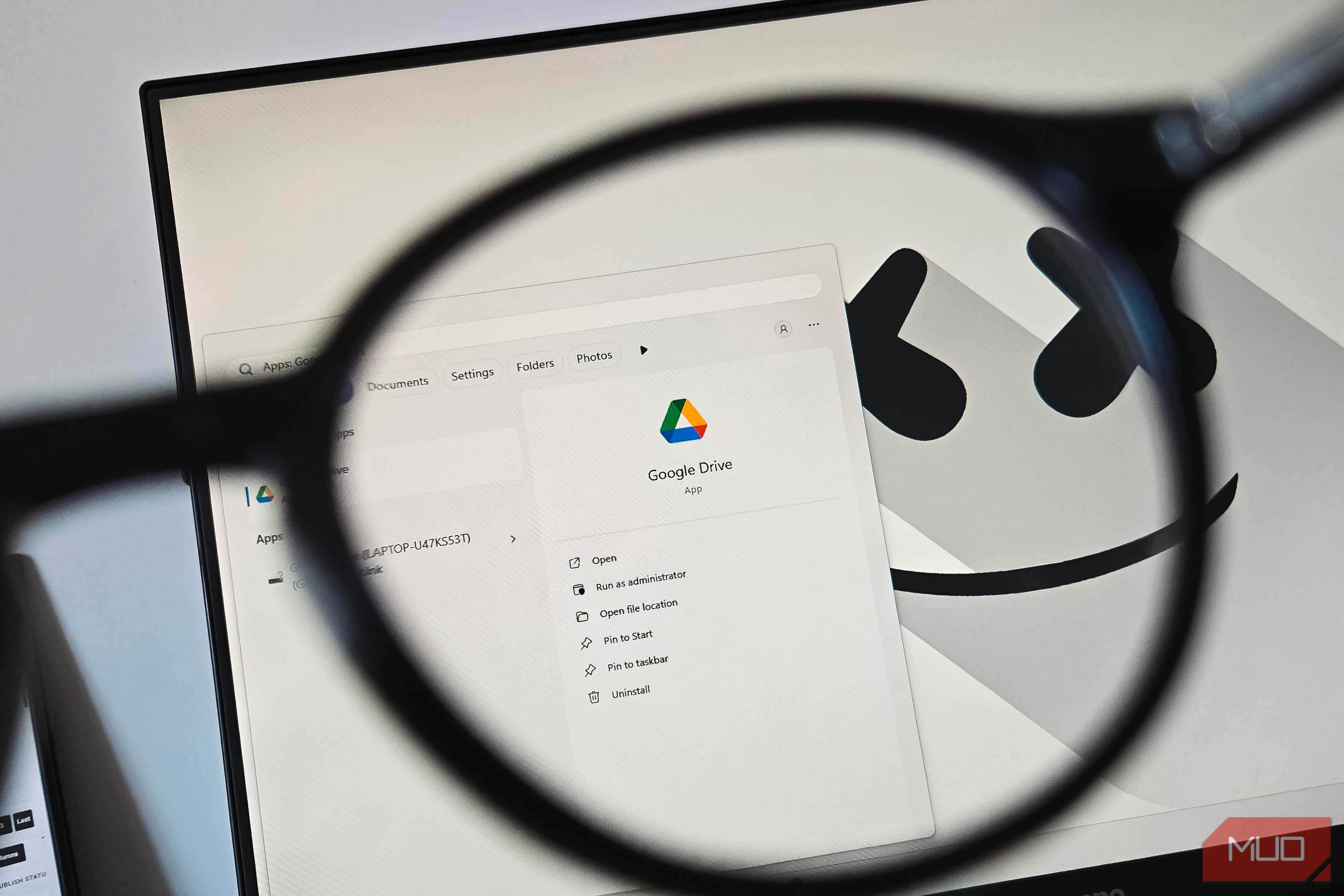 Google Drive app viewed through a magnifying glass on a Windows desktop