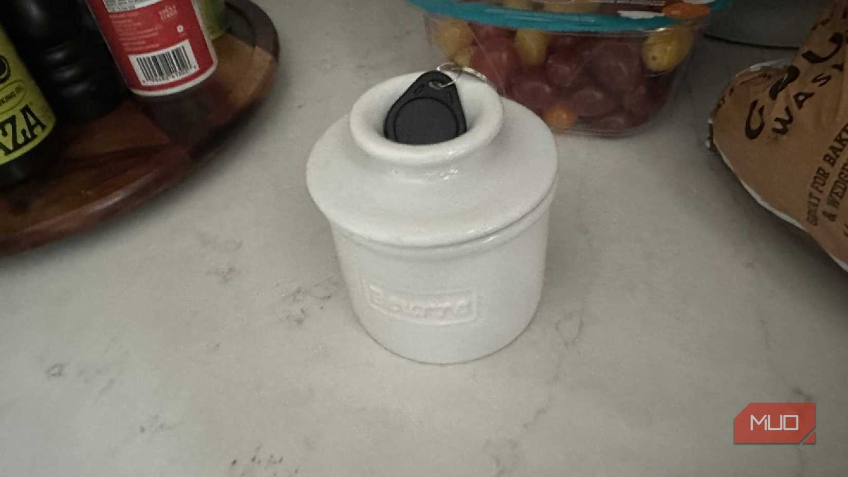 An NFC tag placed on top of a butter bell.