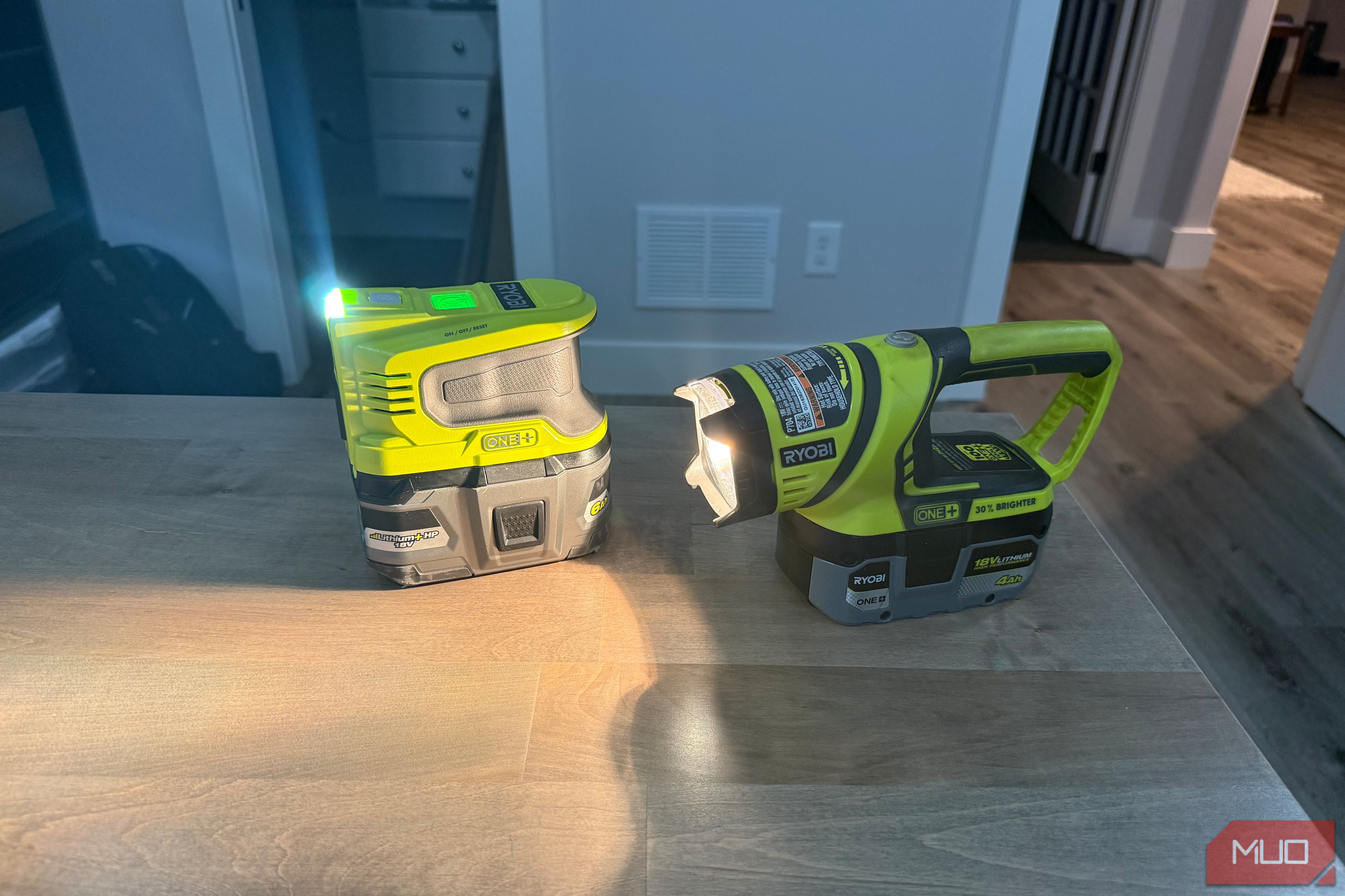 Ryobi power inverter and flashlight on desk beams across surface