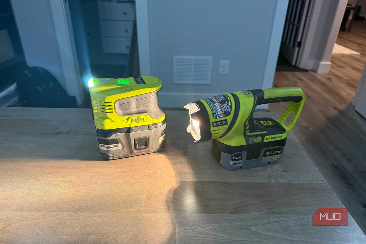 Ryobi power inverter and flashlight on desk beams across surface