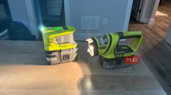 Ryobi power inverter and flashlight on desk beams across surface