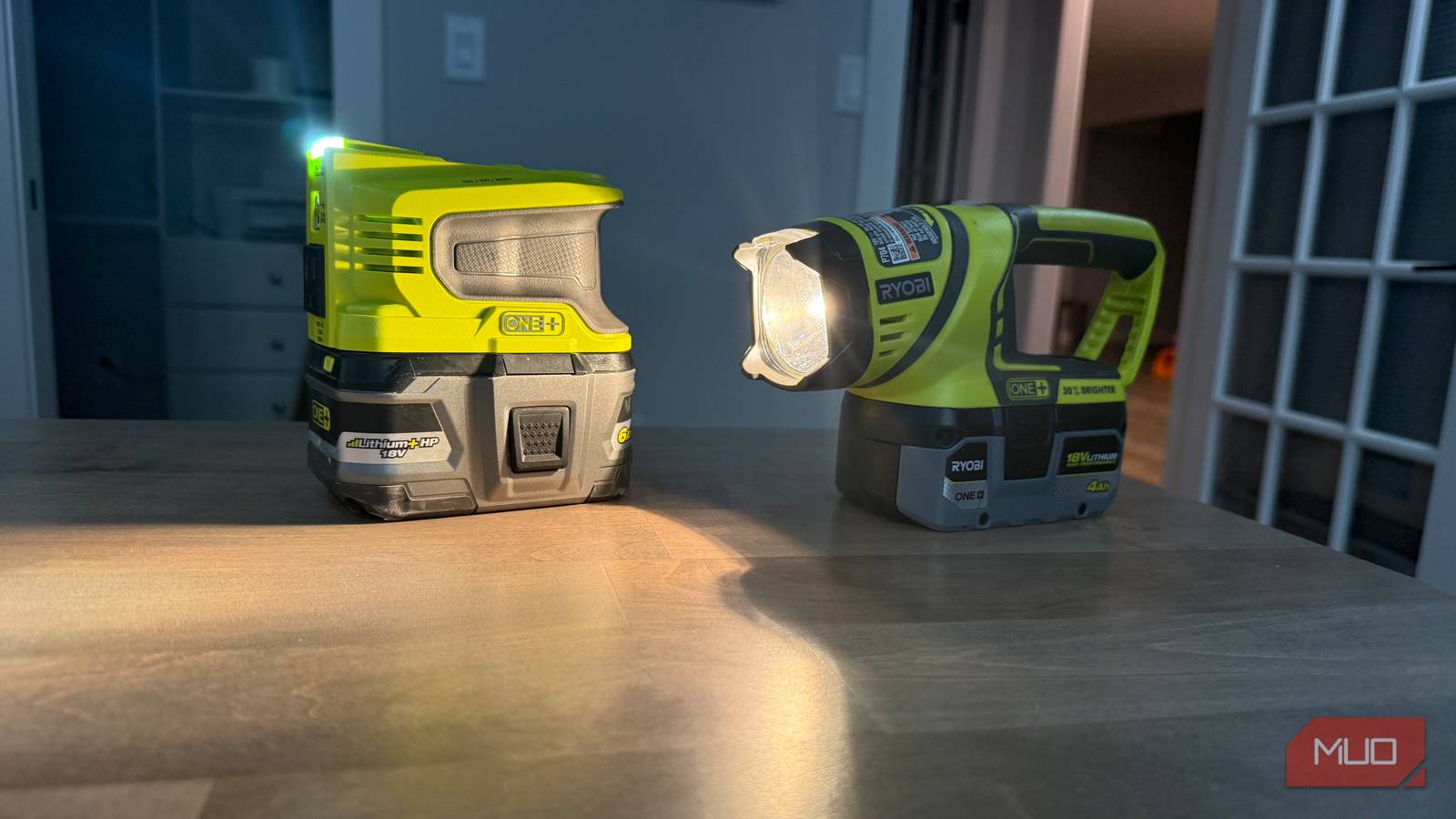 Ryobi power inverter and flashlight on desk shining onto surface