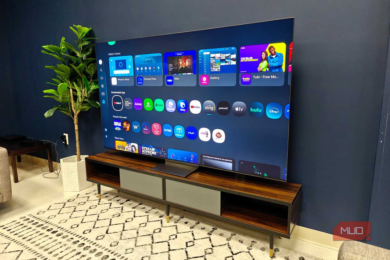 A Samsung QLED TV on a room showing a menu.