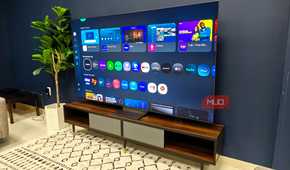 A Samsung QLED TV on a room showing a menu.