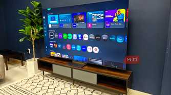 A Samsung QLED TV on a room showing a menu.