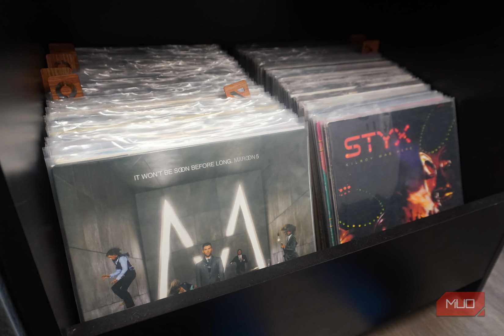 A collection of vinyl records in plastic sleeves.