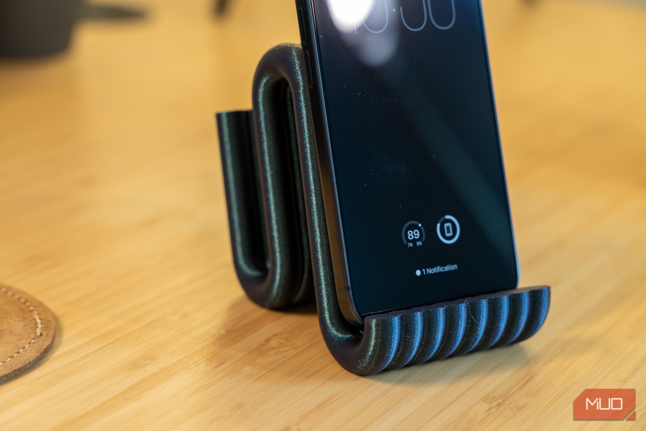 3D printed phone holder close-up with iPhone and ribbed front lip.