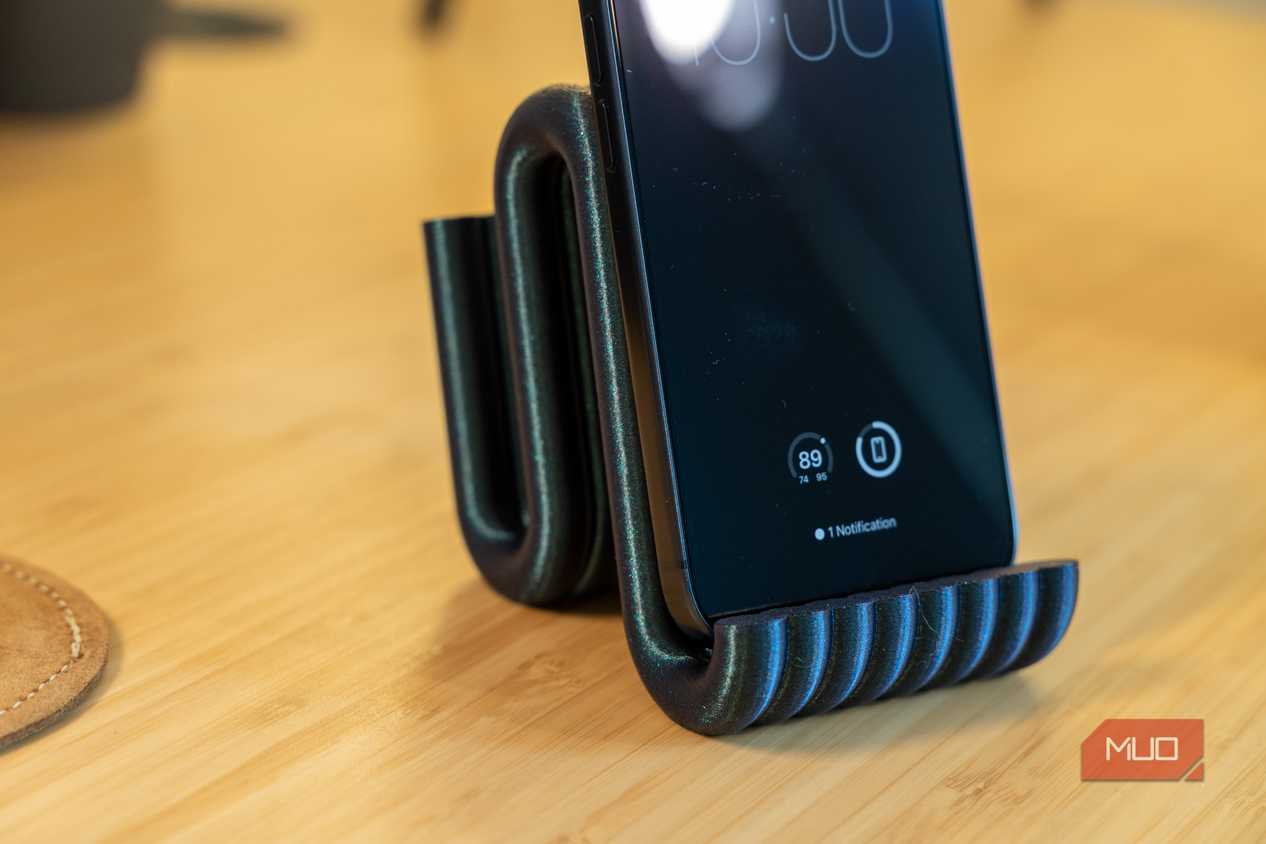 3D printed phone holder close-up with iPhone and ribbed front lip.
