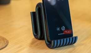 3D printed phone holder close-up with iPhone and ribbed front lip.