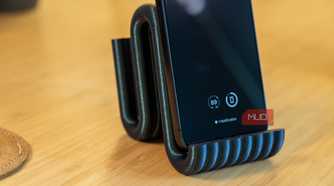 3D printed phone holder close-up with iPhone and ribbed front lip.