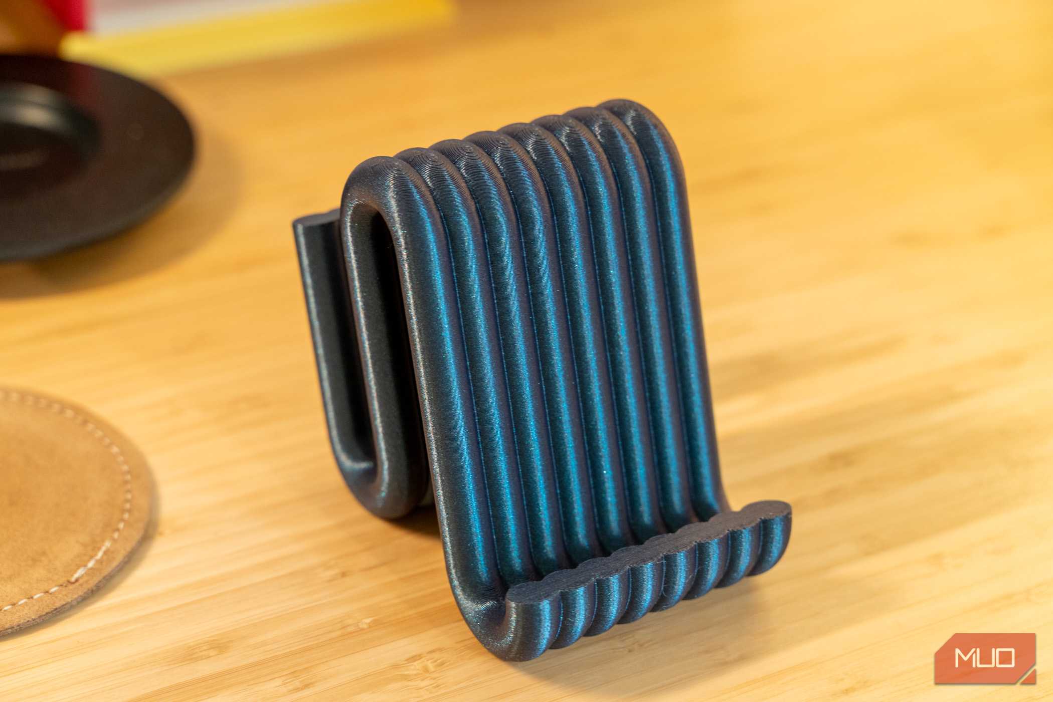 3D printed phone holder empty front view showing ribbed black blue filament.