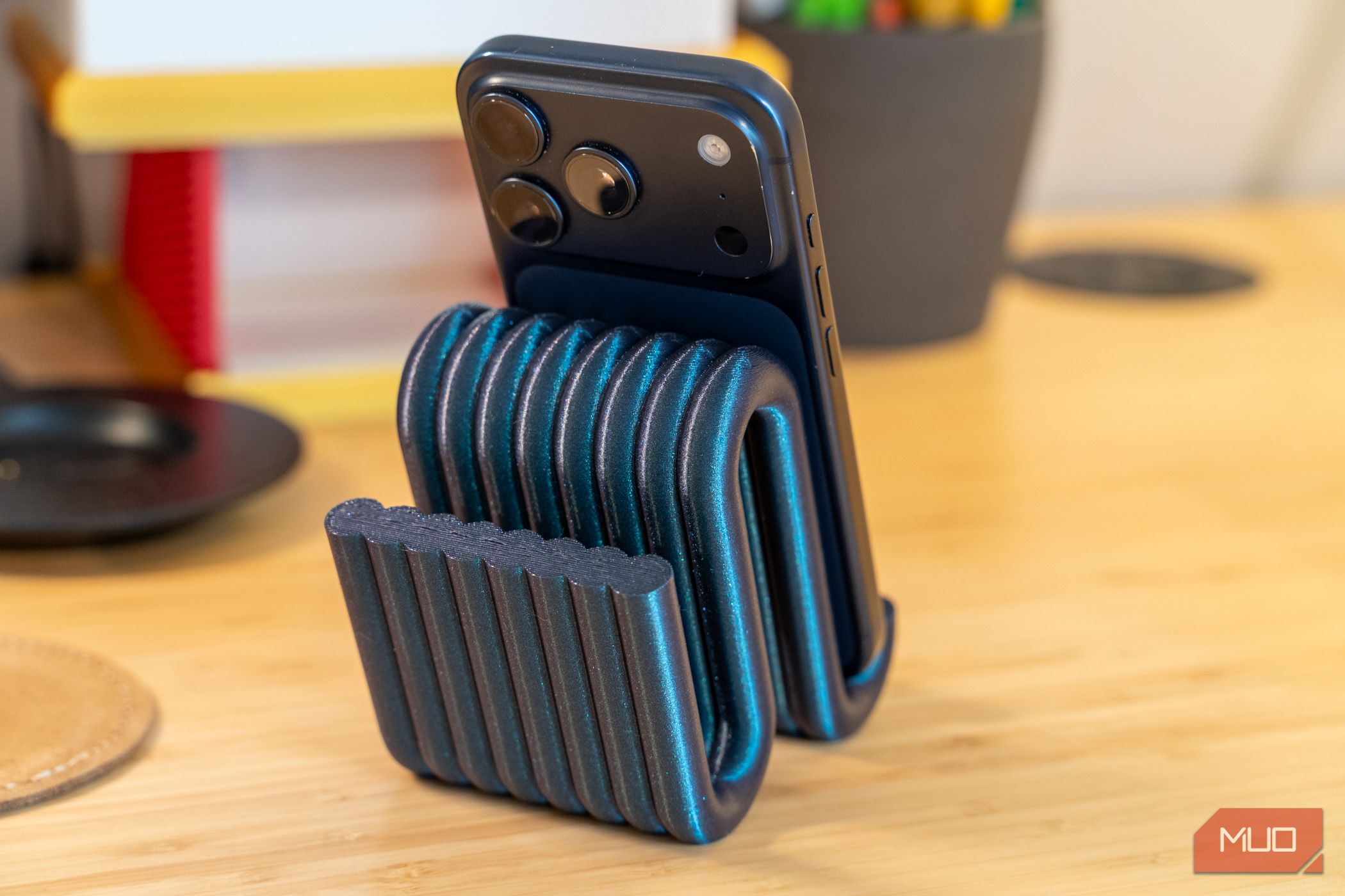 3D printed phone holder rear view with iPhone camera and ribbed support.