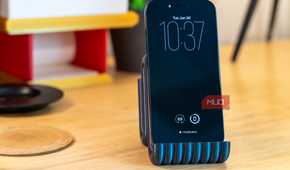3D printed phone holder with iPhone front view on desk.