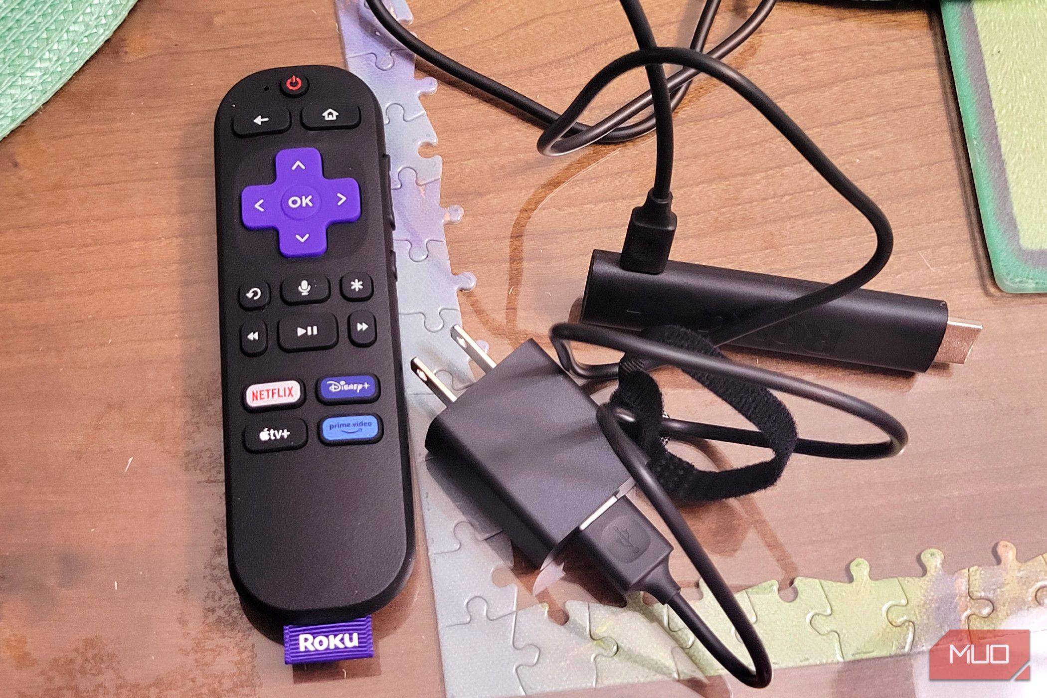 A roku 4k stick next to a plugin