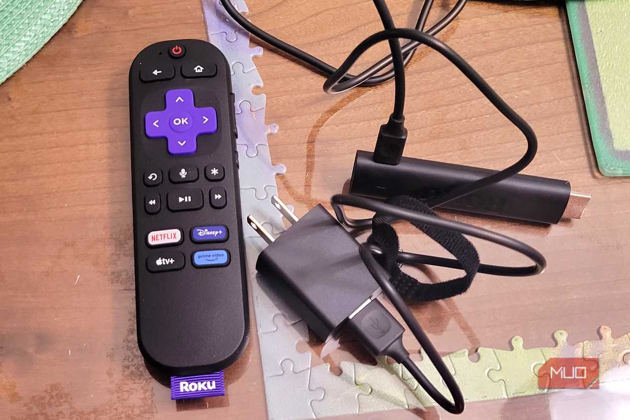 A roku 4k stick next to a plugin