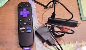 A roku 4k stick next to a plugin