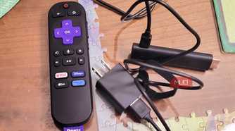 A roku 4k stick next to a plugin