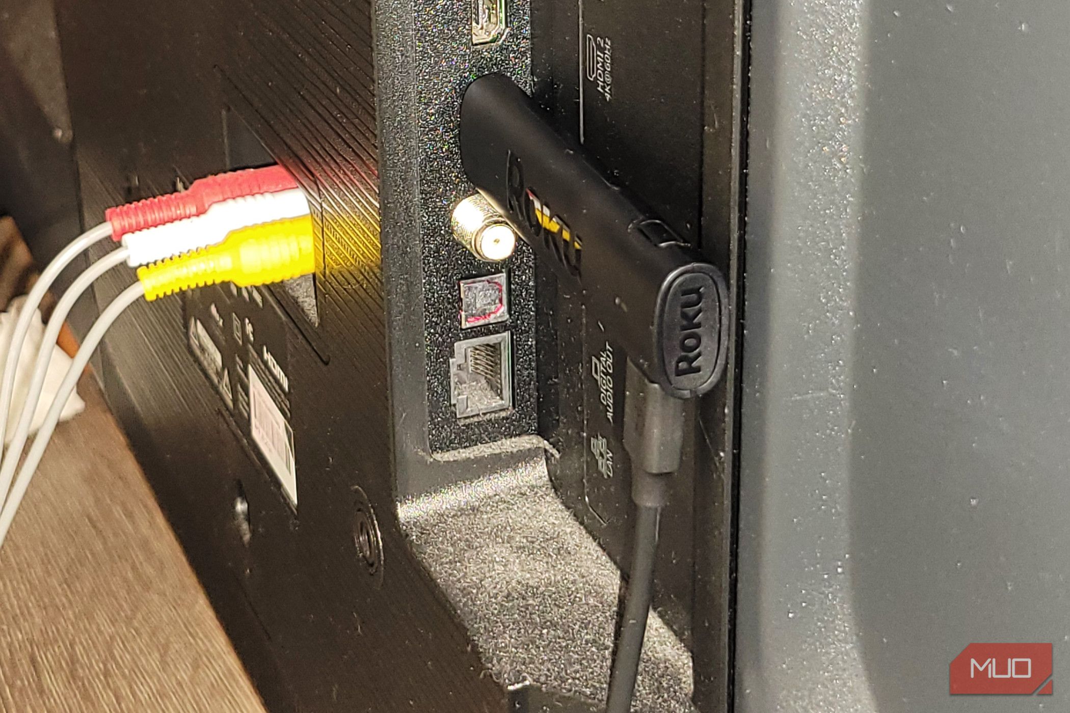 A roku stick on the back of a TV