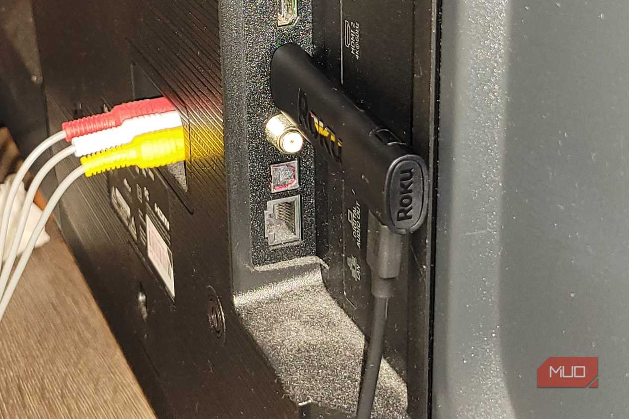 A roku stick on the back of a TV