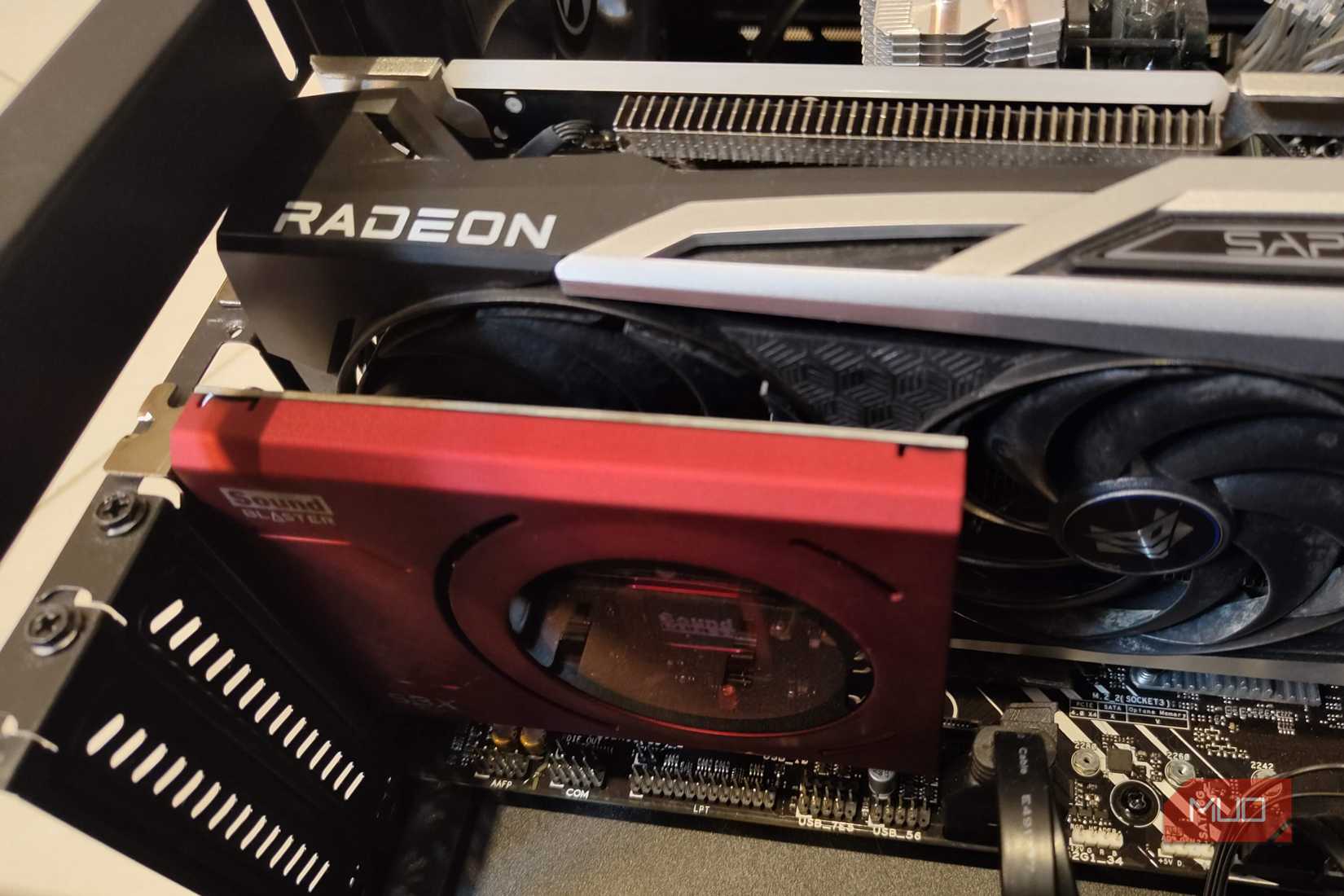 A sound card mounted on a motherboard next to a Radeon graphics card