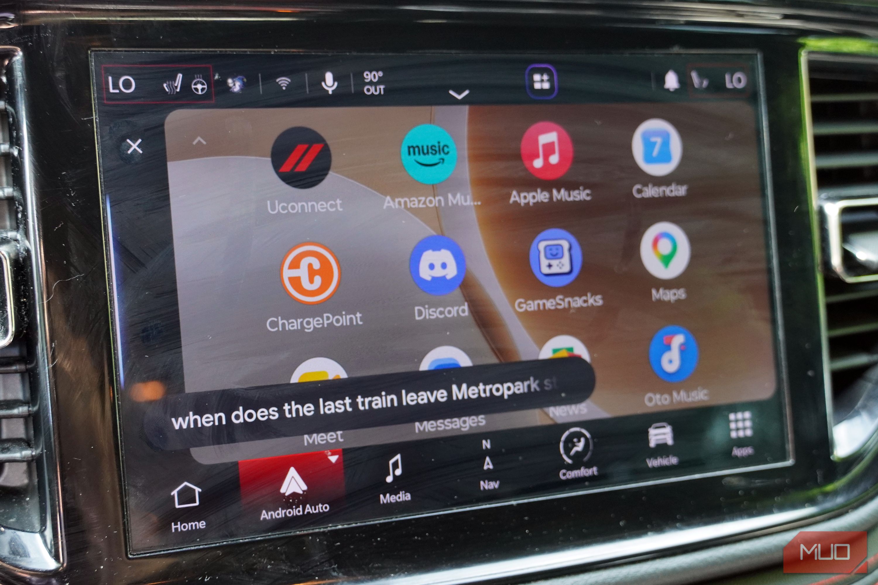Asking Gemini for train information while driving with Android Auto.