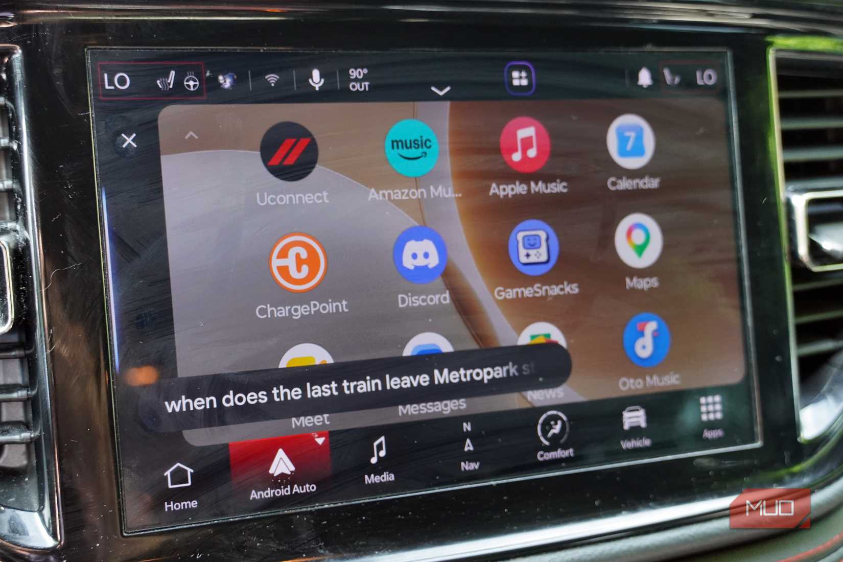 Asking Gemini for train information while driving with Android Auto.