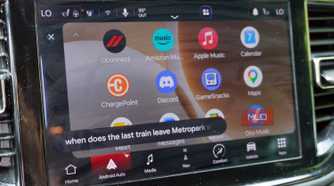 Asking Gemini for train information while driving with Android Auto.
