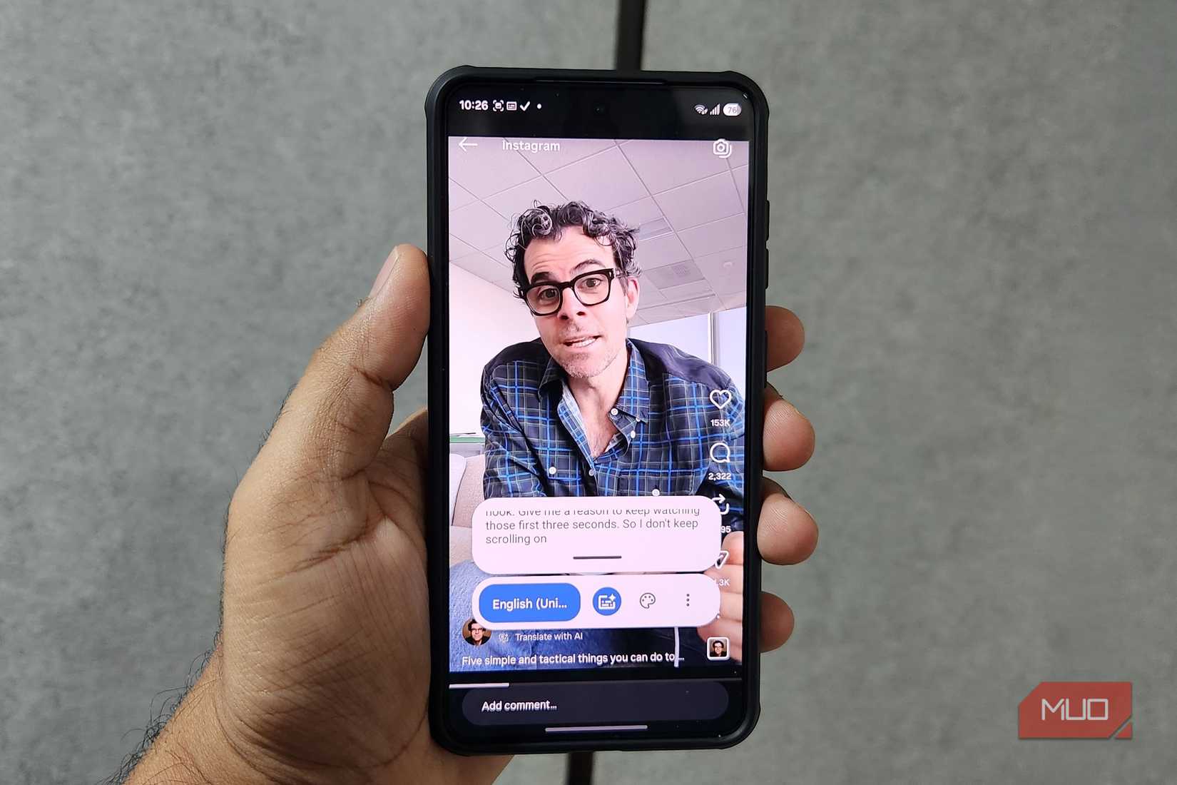Android phone in hand showing captions for an Instagram Reel