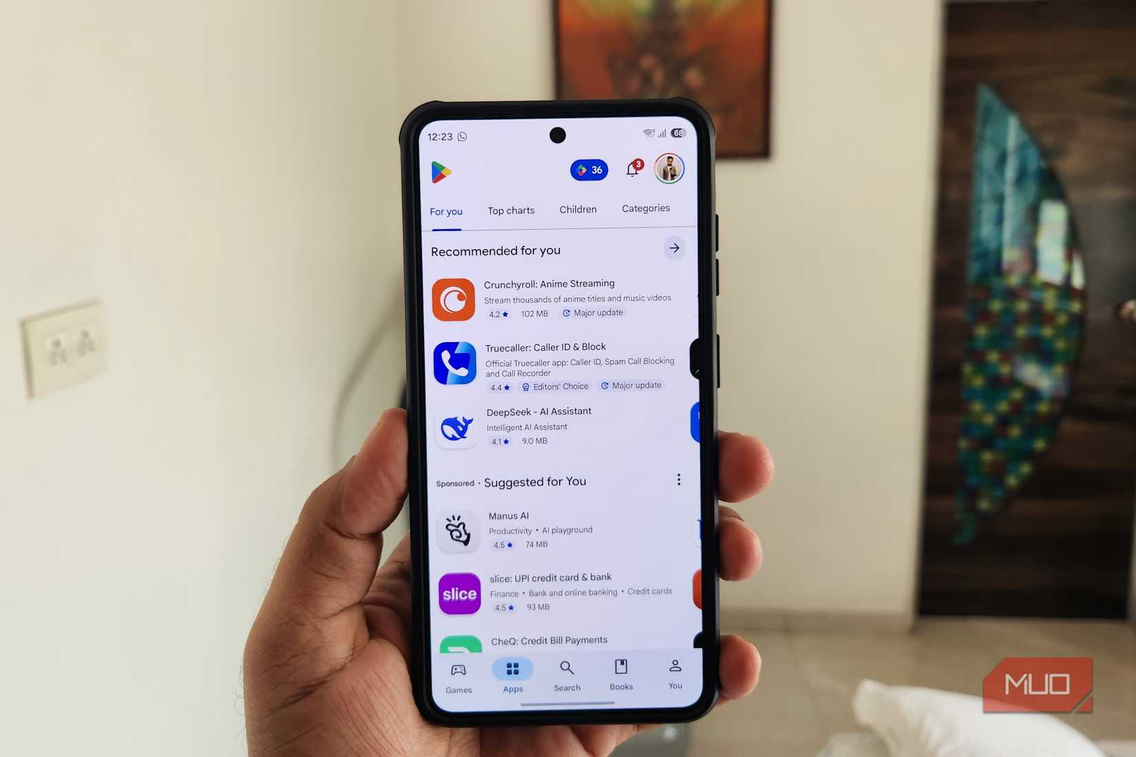 Android phone in hand showing Play Store