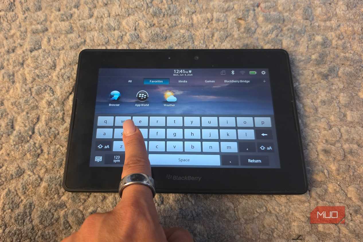 A finger pulling up the virtual keyboard on a BlackBerry PlayBook