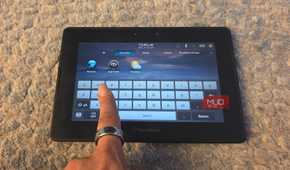 A finger pulling up the virtual keyboard on a BlackBerry PlayBook