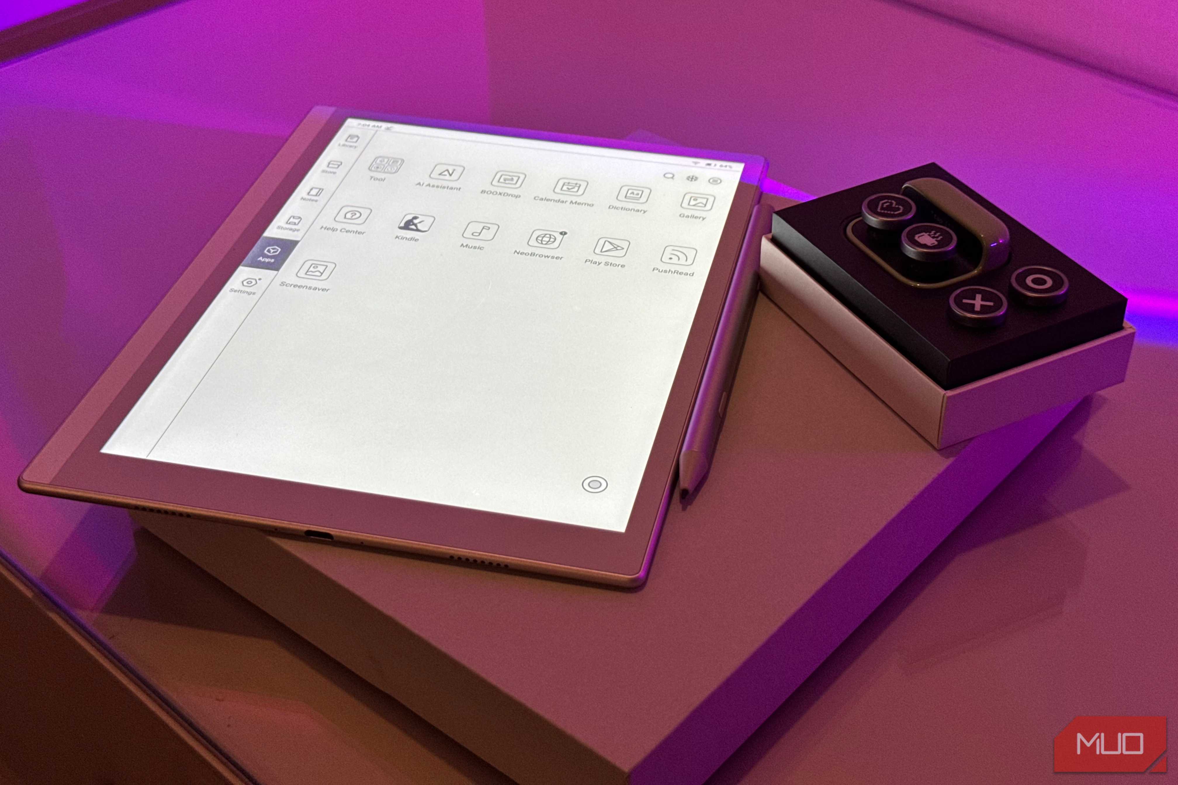 boox tappy case and buttons on box beside boox e-reader app drawer and stylus with purple lighting