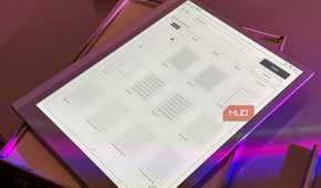 digital tablet displaying user interface wireframe mockups with purple ambient lighting
