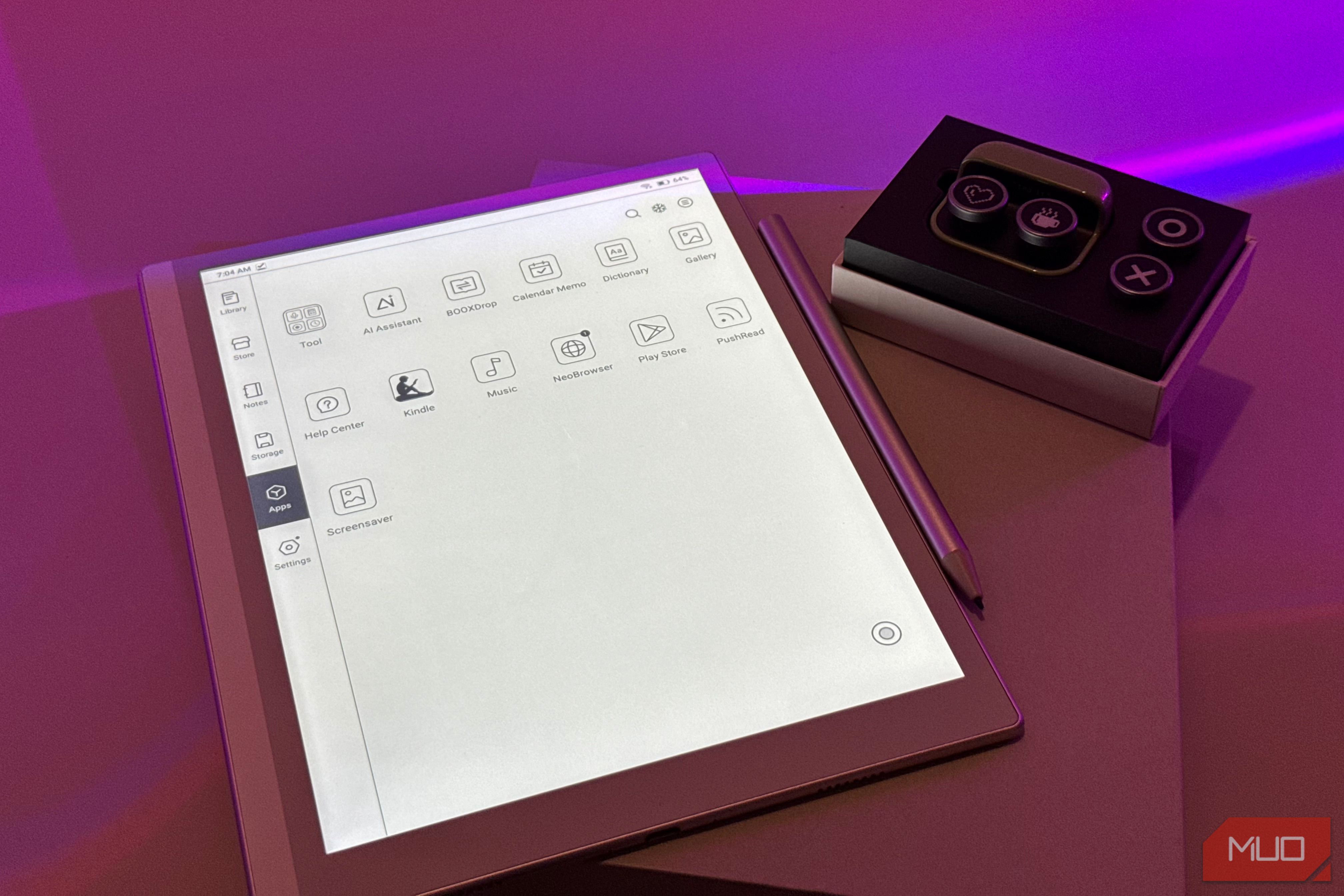 digital tablet with design application interface next to control panel device on purple surface