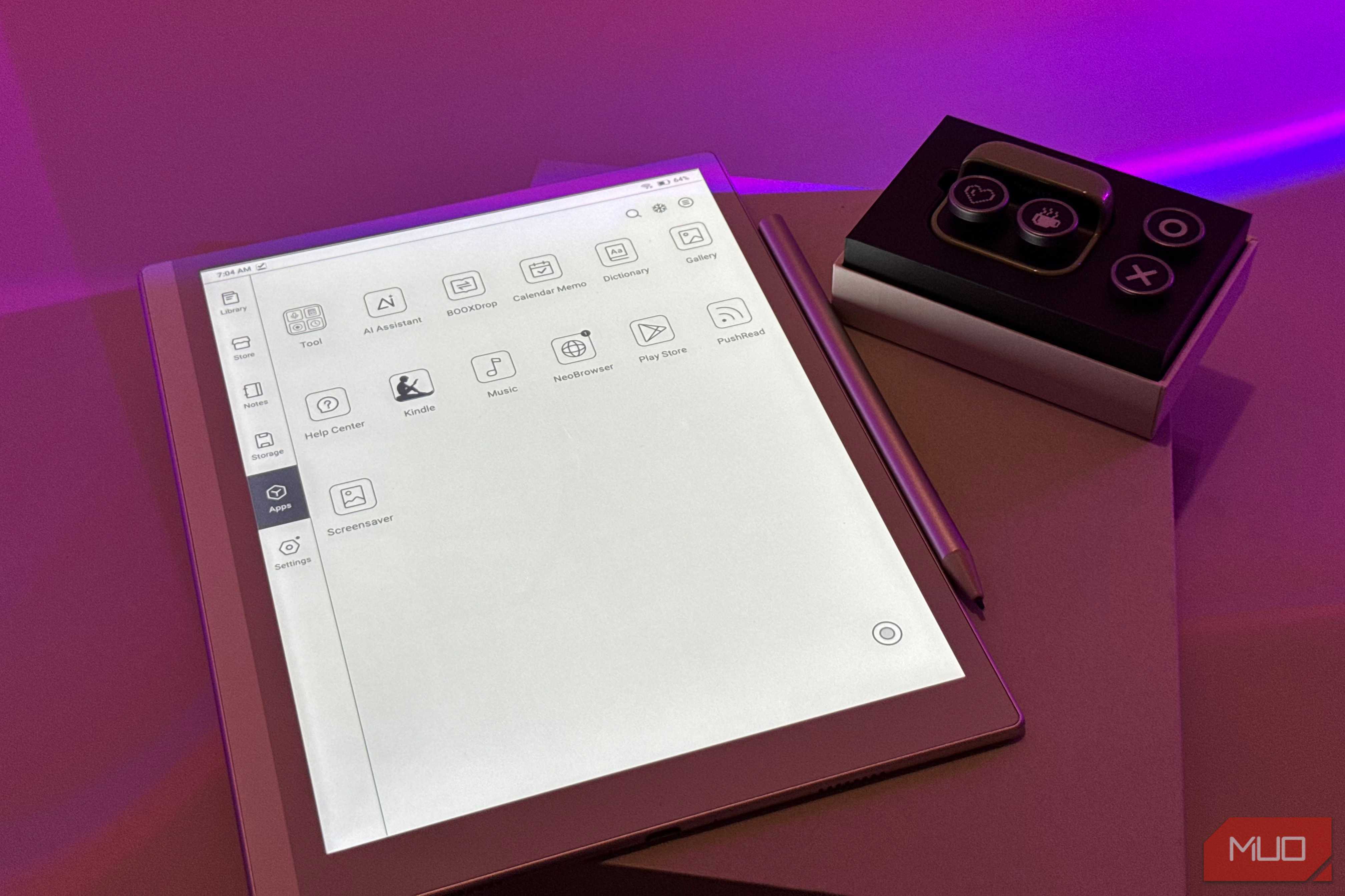 digital tablet with design application interface next to control panel device on purple surface