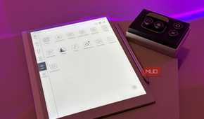 digital tablet with design application interface next to control panel device on purple surface