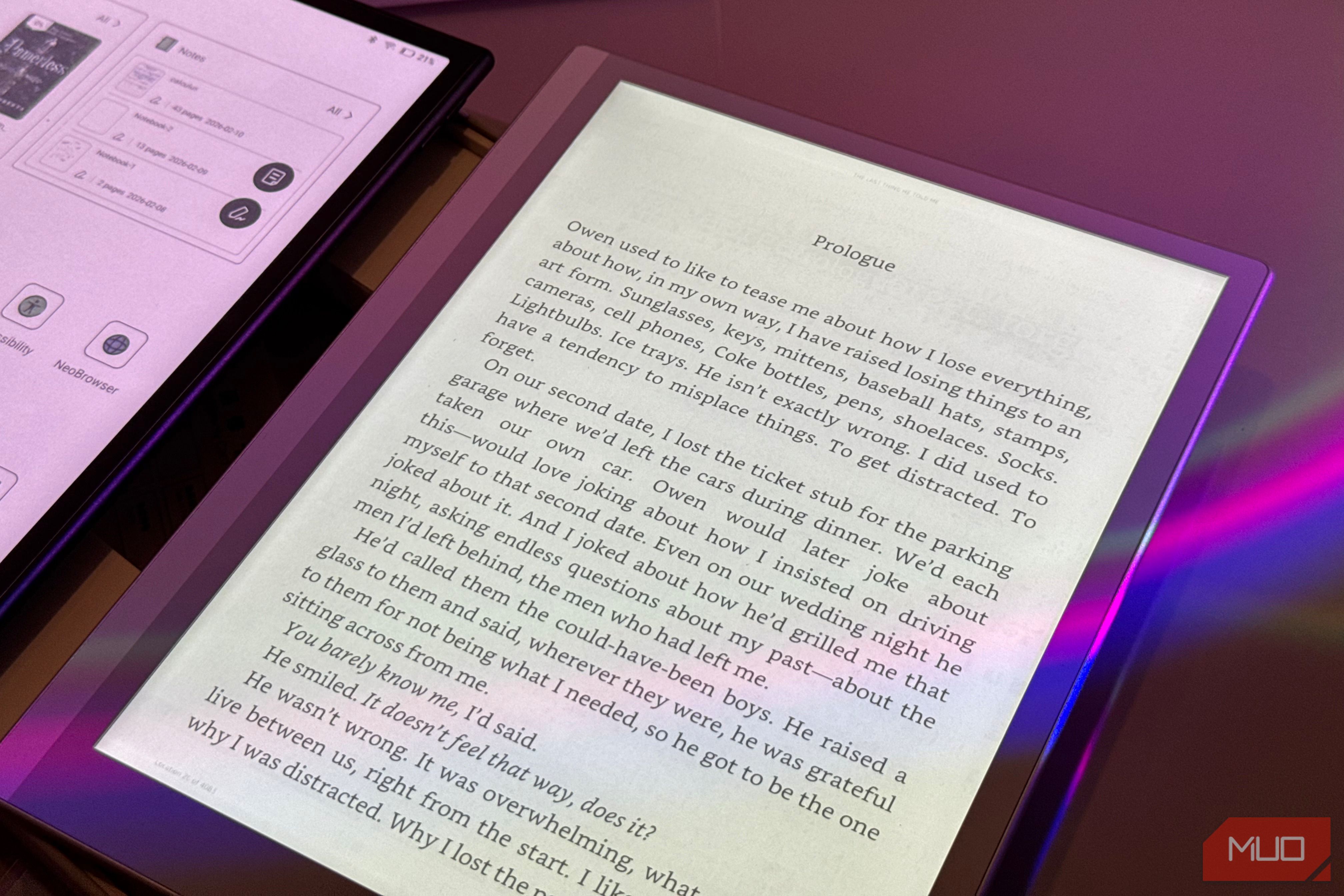 e reader displaying prologue text next to tablet showing digital interface with purple lighting