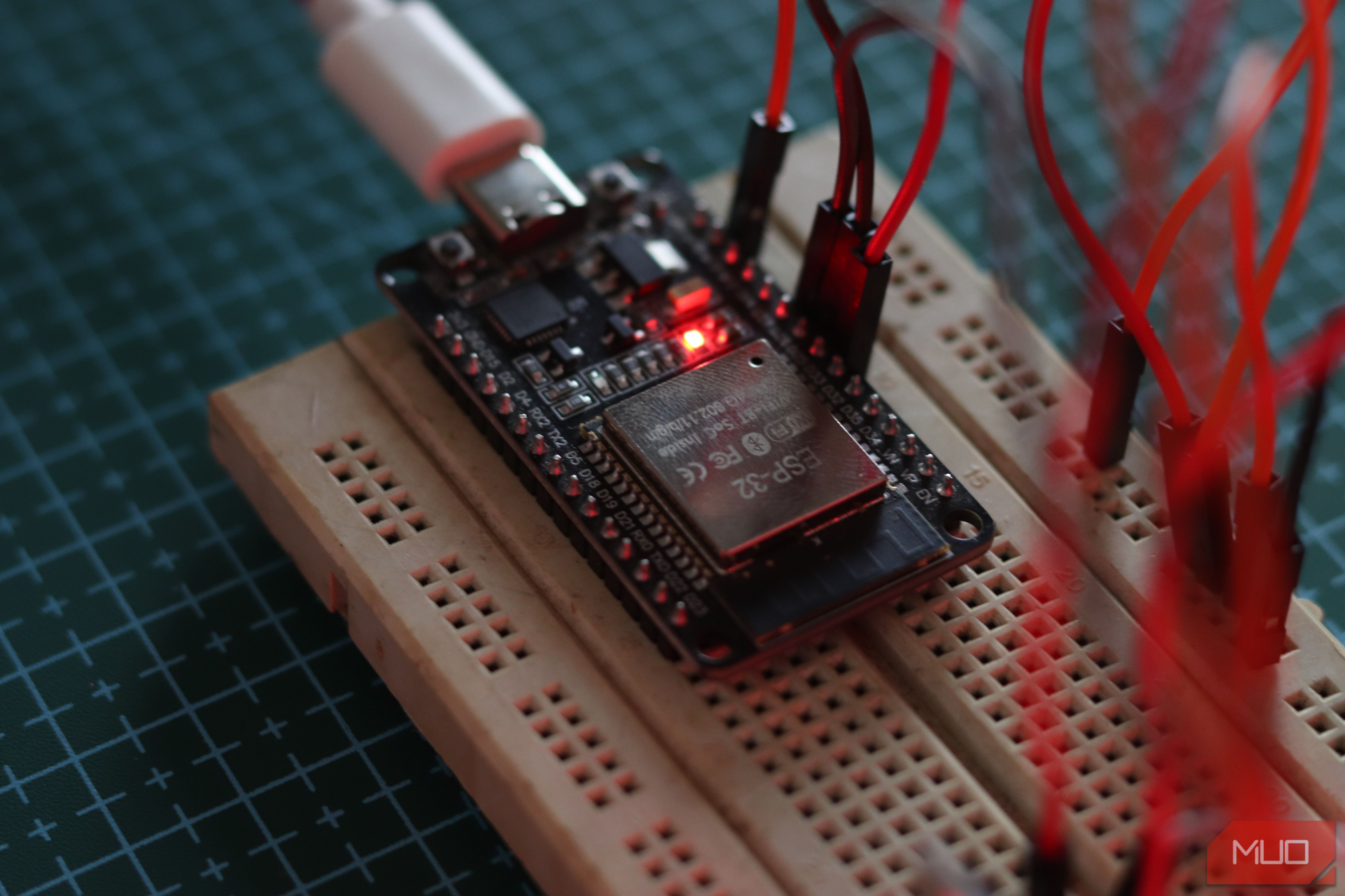 ESP32 on a breadboard with jumper cables connected.