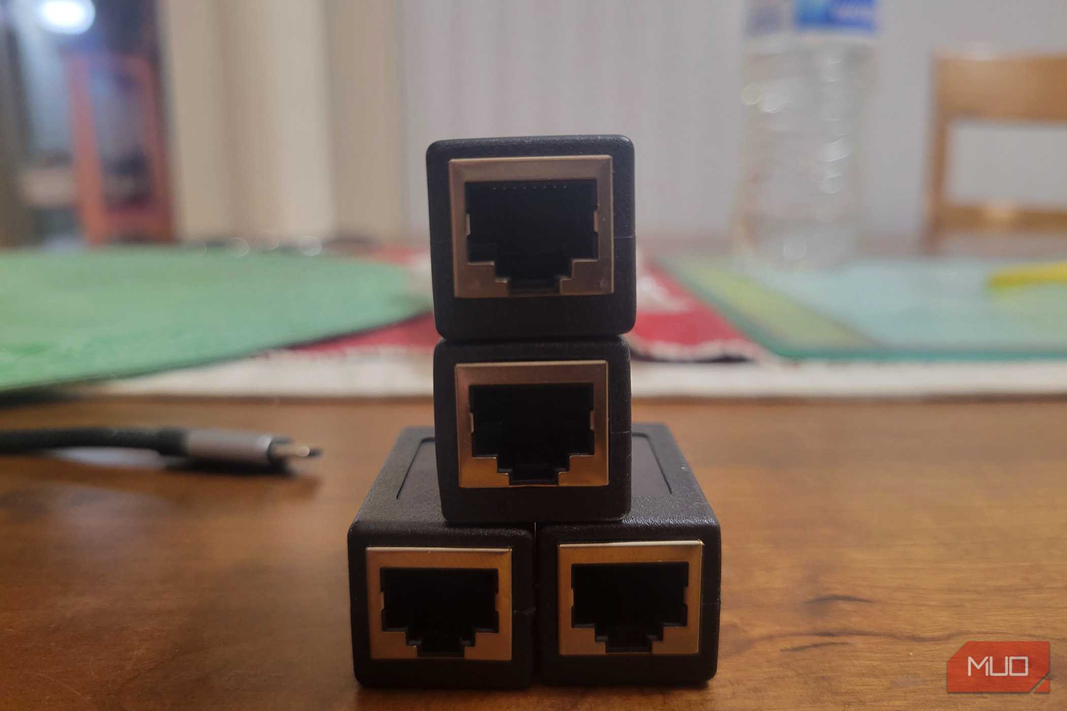 Four Ethernet ports lined up like a Creeper next to a dongle