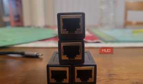 Four Ethernet ports lined up like a Creeper next to a dongle