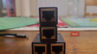Four Ethernet ports lined up like a Creeper next to a dongle