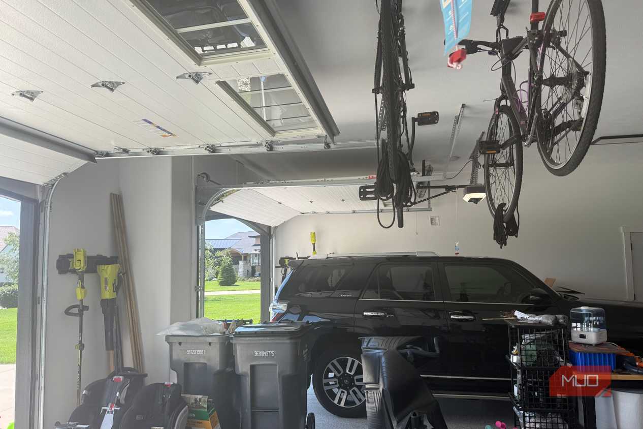 garage interior with black suv and ceiling mounted bikes