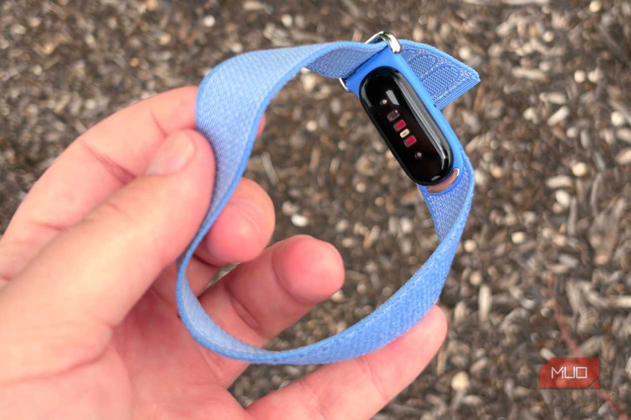 Holding the Fitbit Air in the hand.