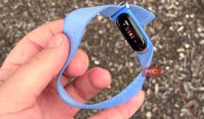 Holding the Fitbit Air in the hand.
